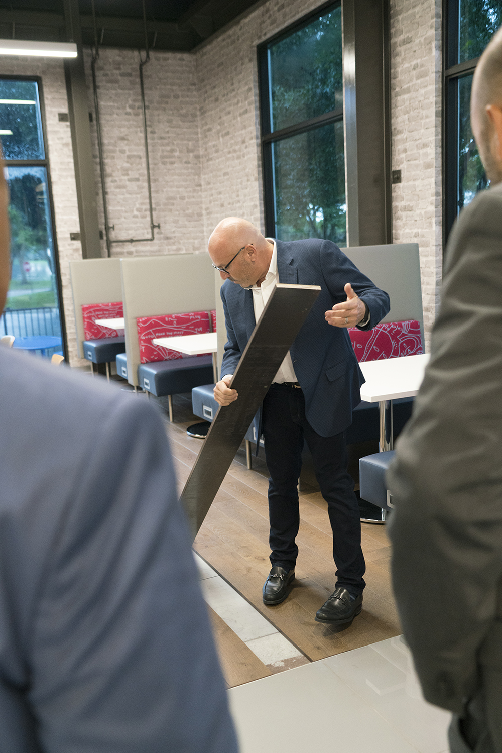 JC White CEO Mark Feltingoff shows off magnetic flooring during a tour