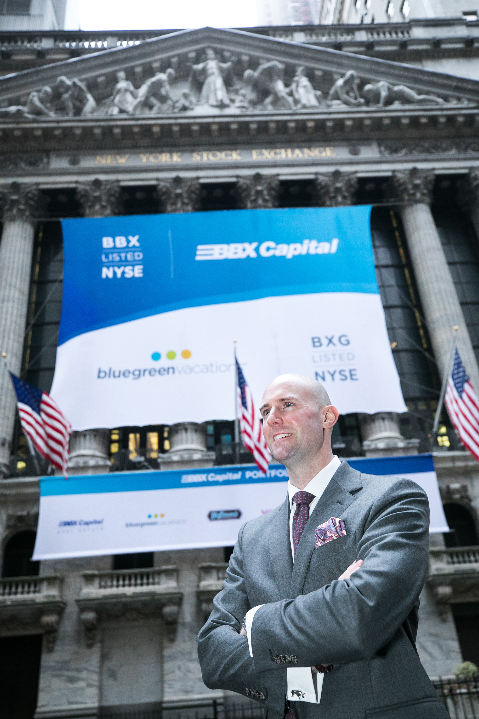 Pearson at the New York Stock Exchange in front of a banner for Bluegreen and parent BBX Capital