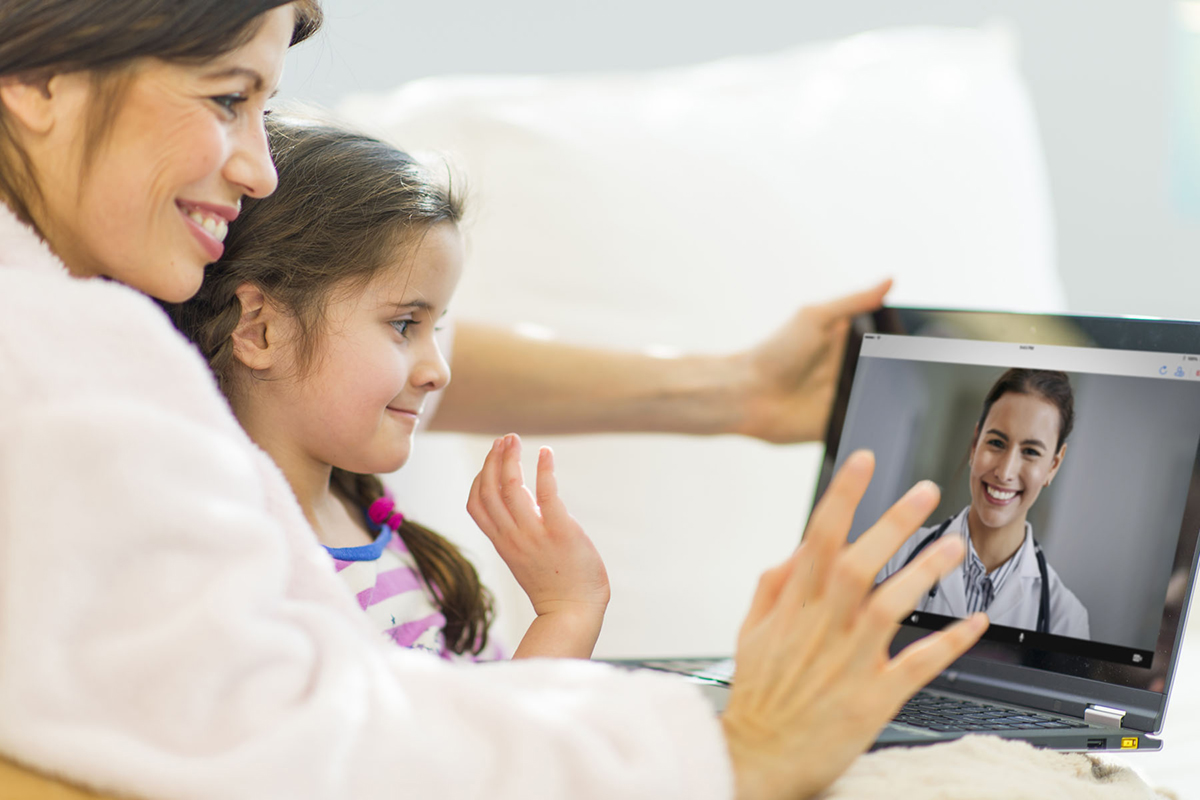 A mother and daughter have a virtual visit with a doctor via an app available from Baptist Health