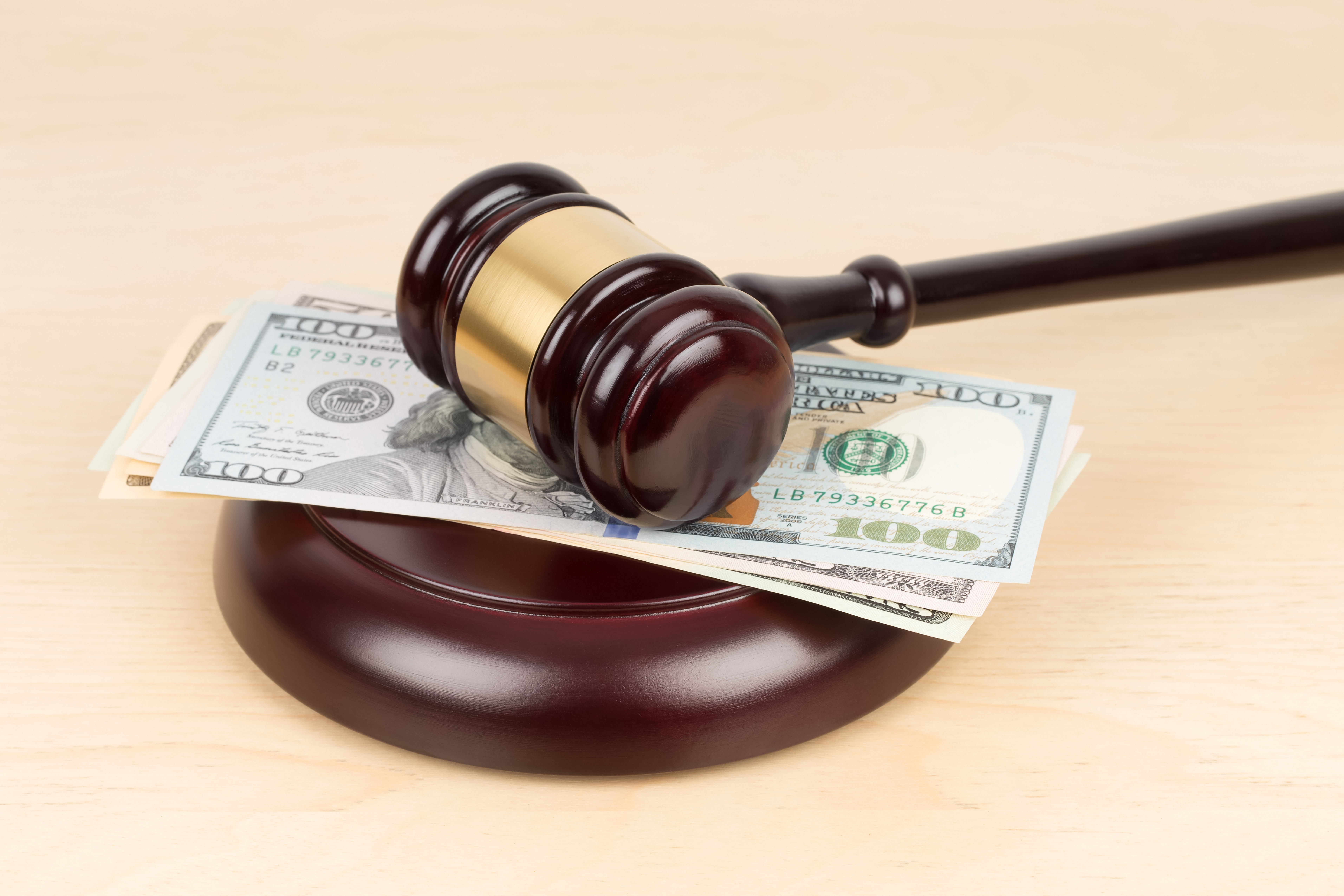 Judge wooden gavel with dollar money banknote